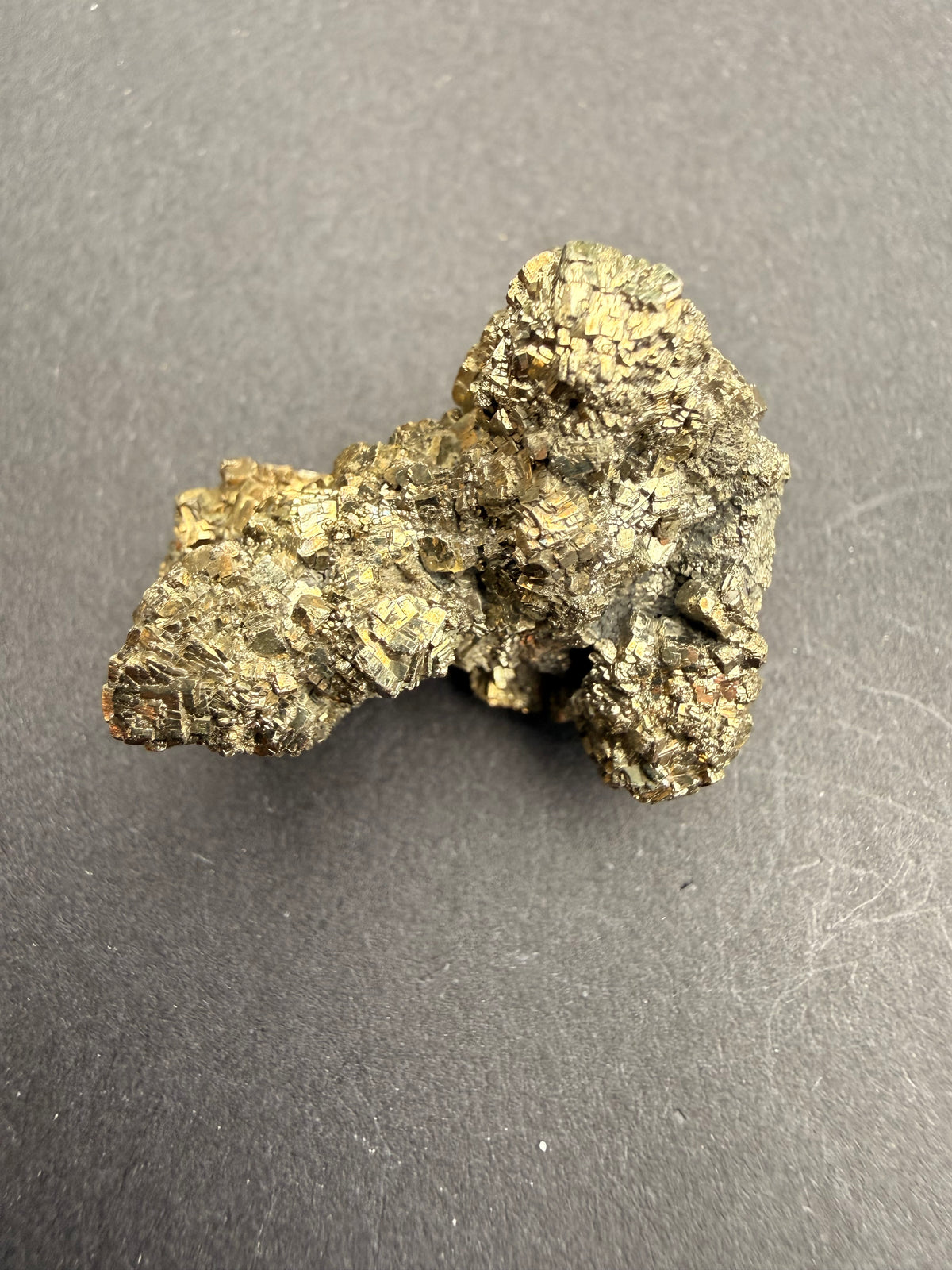 Close-up of cubic pyrite crystal facets covering the specimen surface