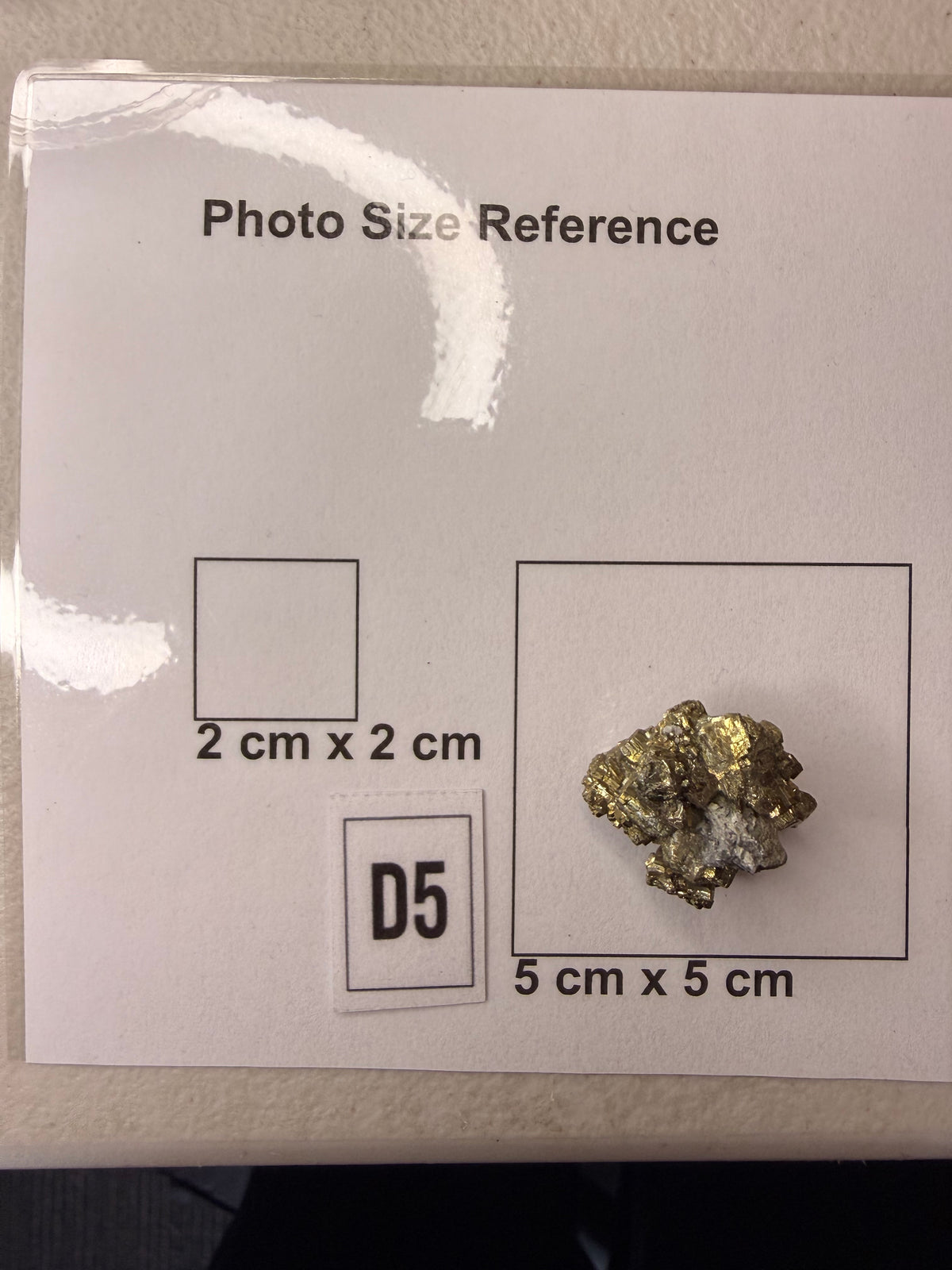 Pyrite cluster full view on grey background