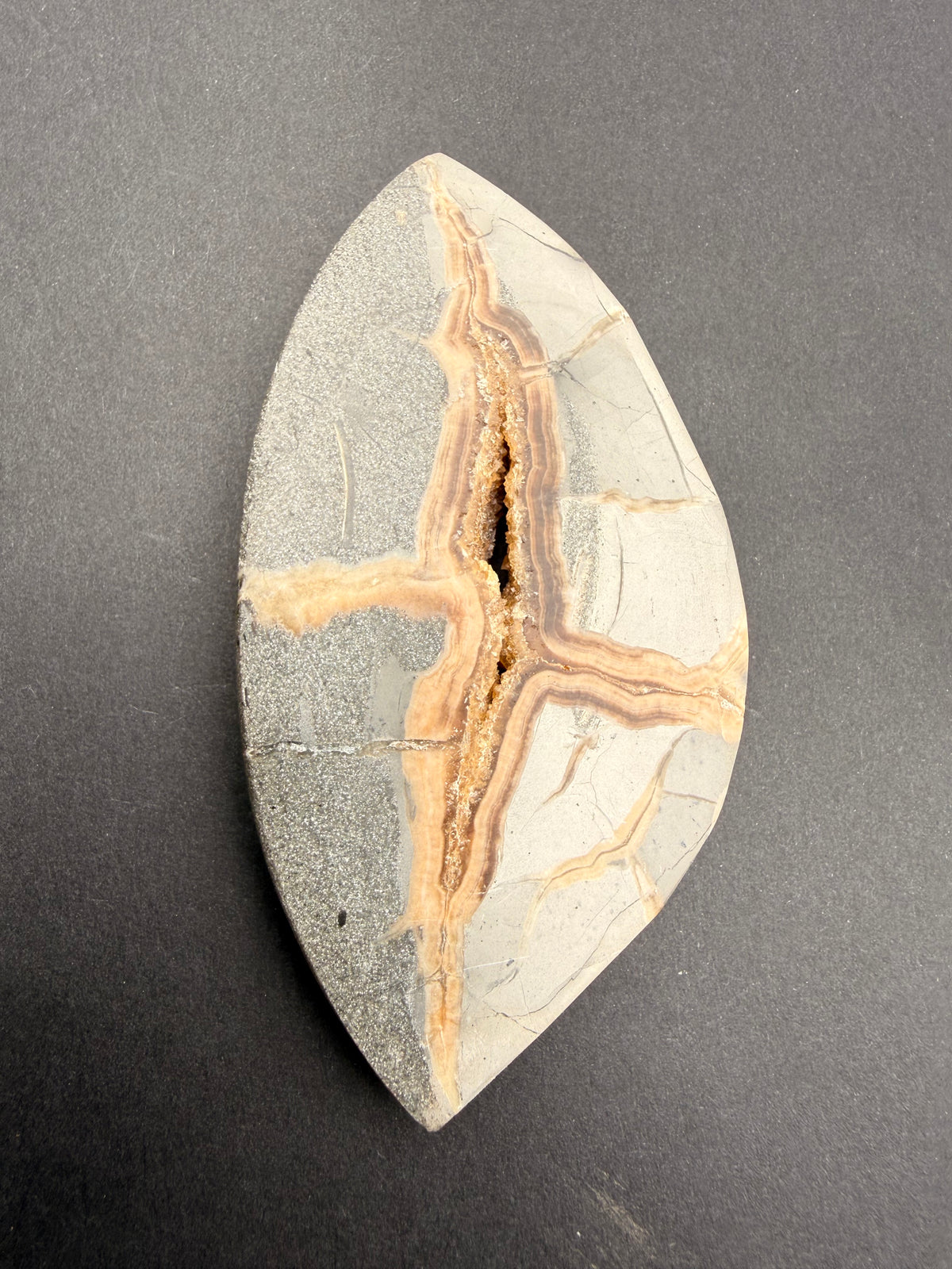 Septarian nodule close-up of orange calcite vein and natural crystal cavity