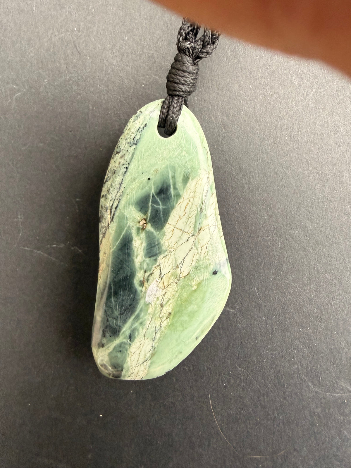 Serpentine necklace close-up showing green stone patterning