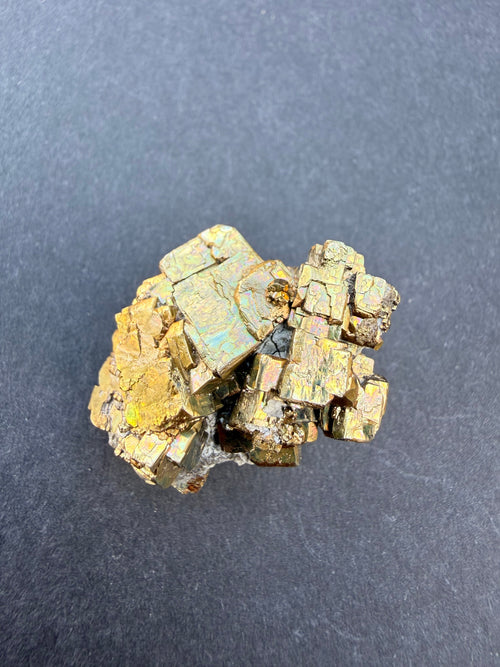 Close-up of iridescent pyrite crystal faces showing colour shift, New Zealand