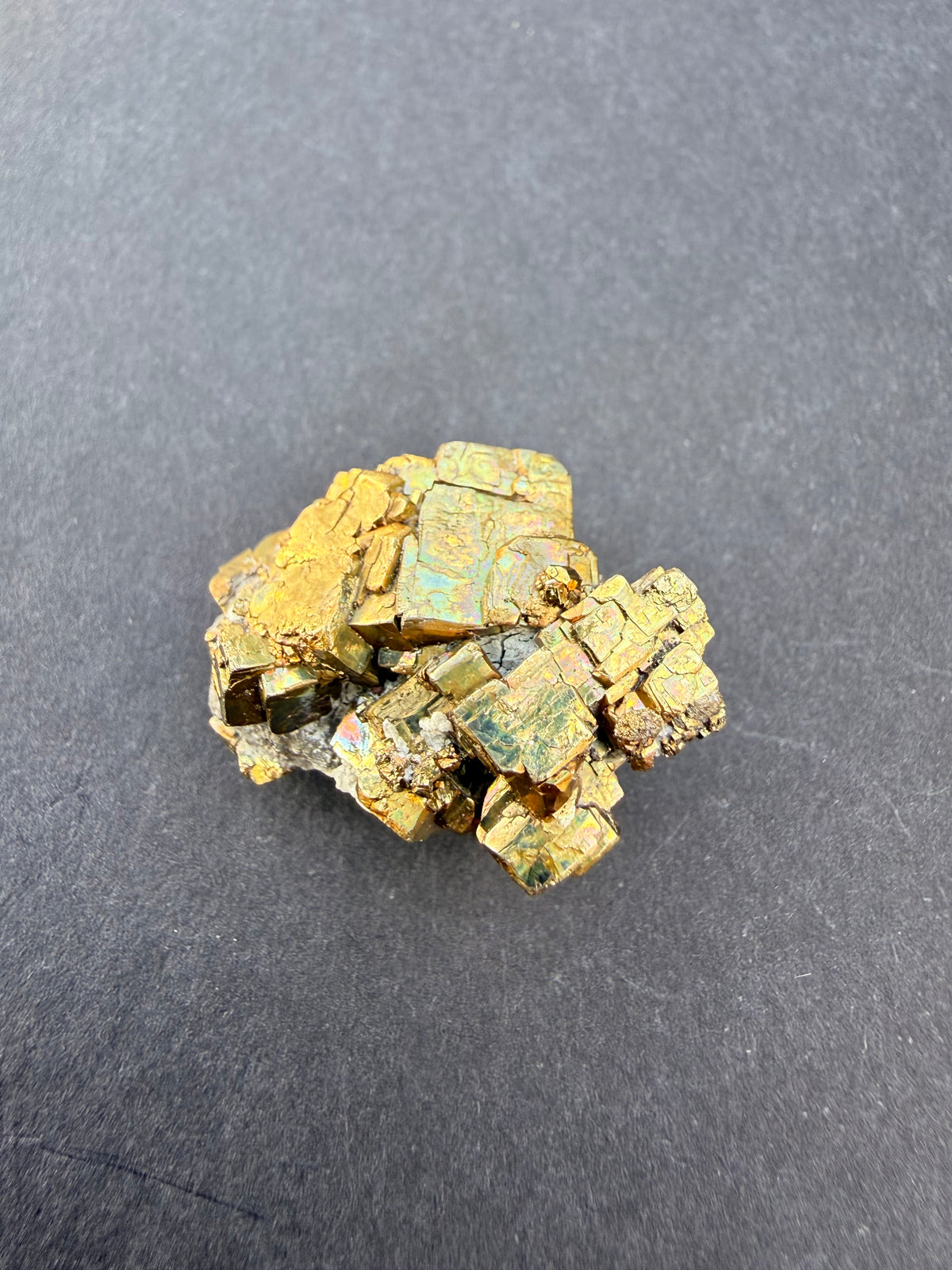 Iridescent pyrite cluster with rainbow colour flash on crystal faces, New Zealand