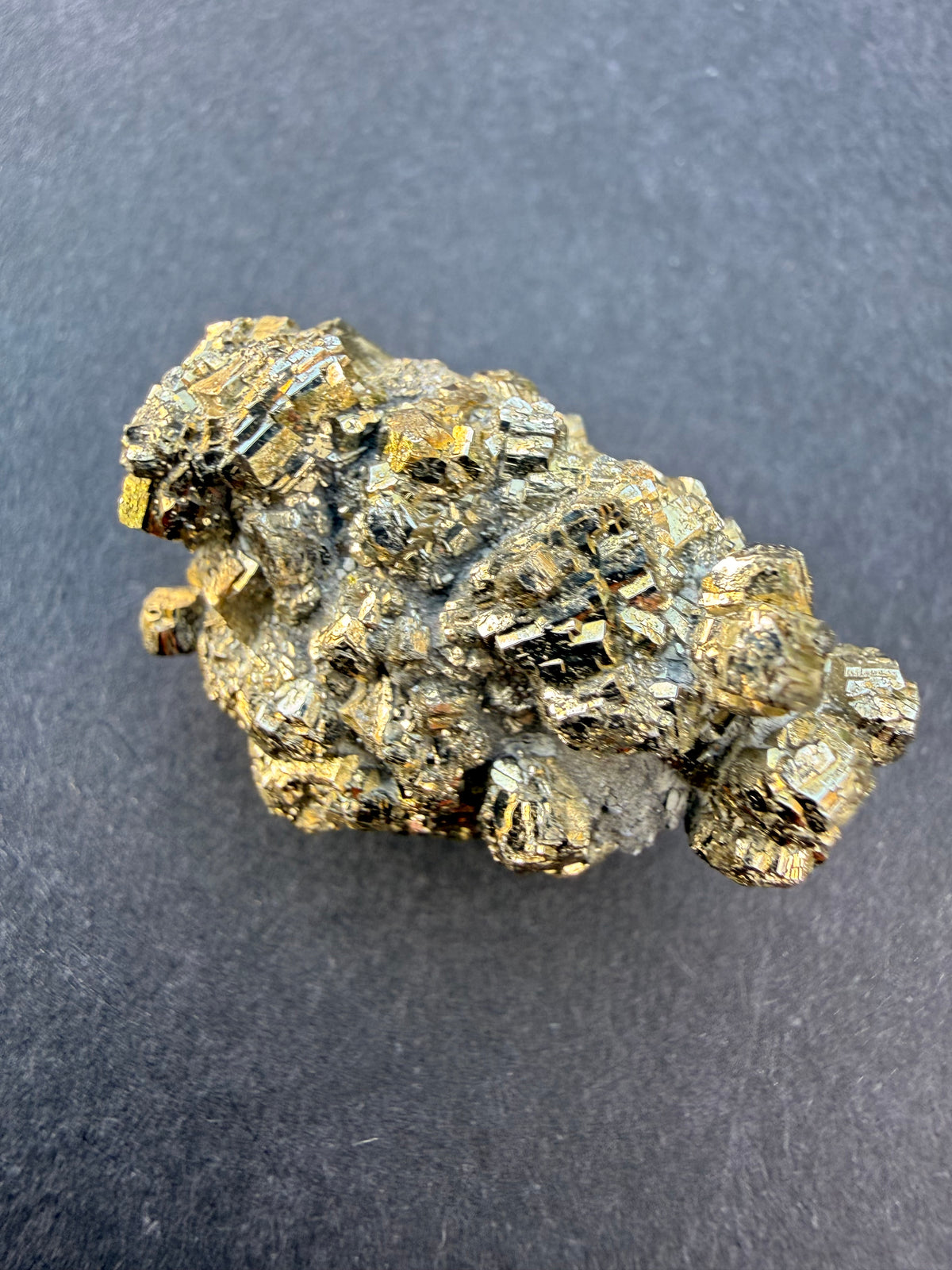 Close-up of small pyrite crystal faces packed densely across the surface